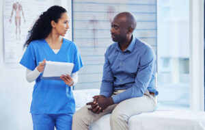 Patient, nurse and healthcare clipboard in hospital for health insurance consultation. Patient and professional nurse woman talking about symptoms, wellness and questions or advice for healthy life