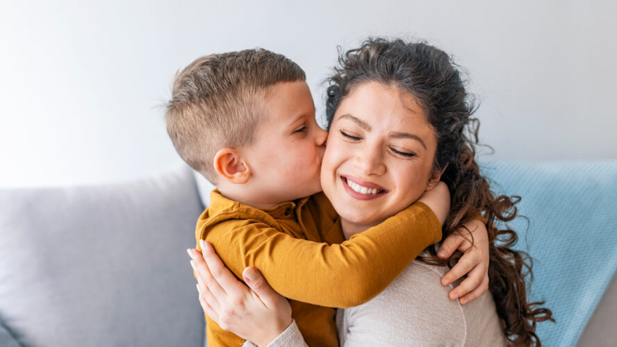Son is kissing his mother. The kind of love that can't be described, only felt. Mom and son. Happy mother's day! Mother hugging her child
