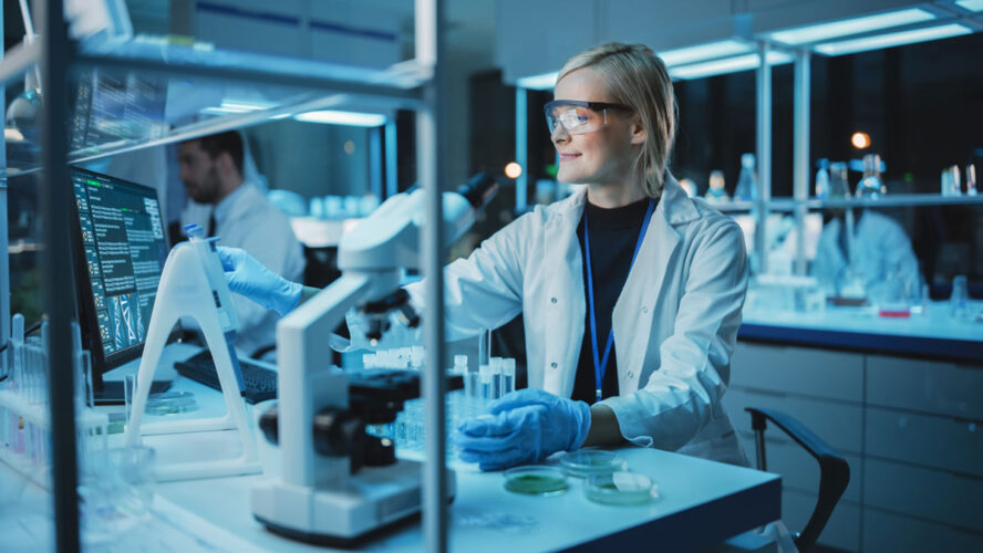 Female Research Scientist Uses Micropipette to Mix Liquids in a Sample Test Tube in a Modern Laboratory. Scientists are Conducting DNA Research with the Help of Technology, Microscopes and Computers