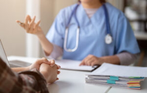 Close-up hand image of a serious patient having a medical consultation with a doctor.