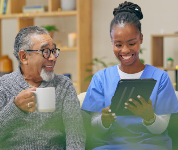 Home, old man and nurse with a tablet, conversation and email notification with internet, love and social media