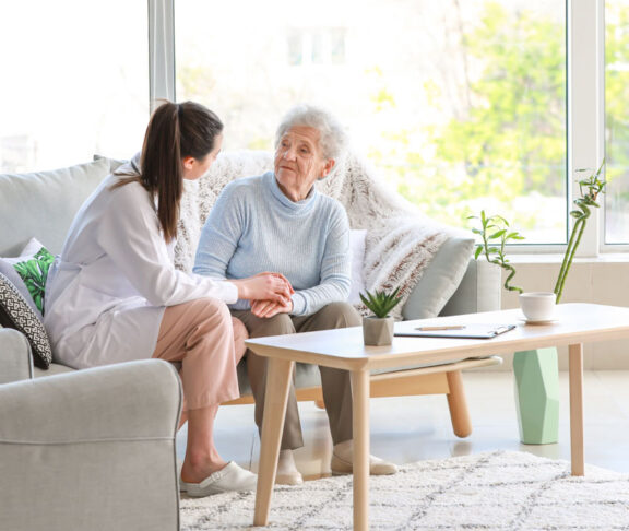 Doctor with senior woman in nursing home