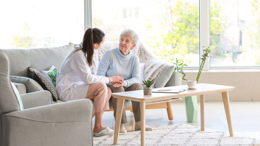 Doctor with senior woman in nursing home