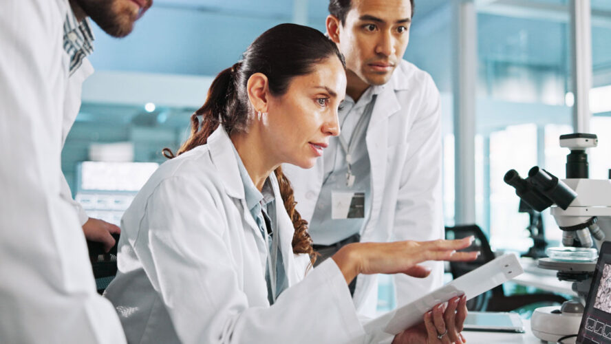 Teamwork, talking or scientists on laptop for medical breakthrough, clinical trial or DNA discovery. People, biology testing or science research in lab with results notes, bacteria or medicine cure