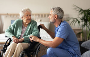 Caregiver doing regular check-up of senior woman in her home.