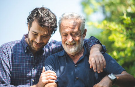 caucasian senior father and adult son are hugging together at home, generation family are happy with people love, male mature, old person man, elderly grandfather smiling living at the house