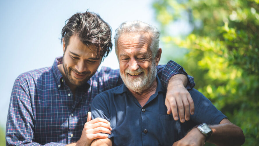 caucasian senior father and adult son are hugging together at home, generation family are happy with people love, male mature, old person man, elderly grandfather smiling living at the house