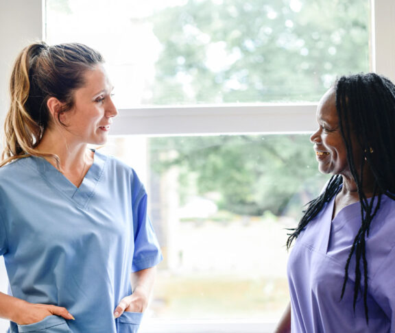 Nurses having a conversation in the hospital hallway