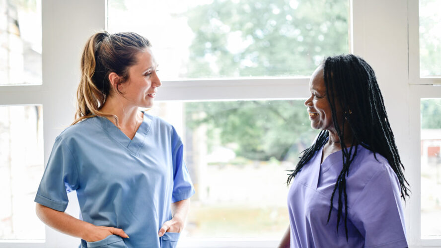 Nurses having a conversation in the hospital hallway