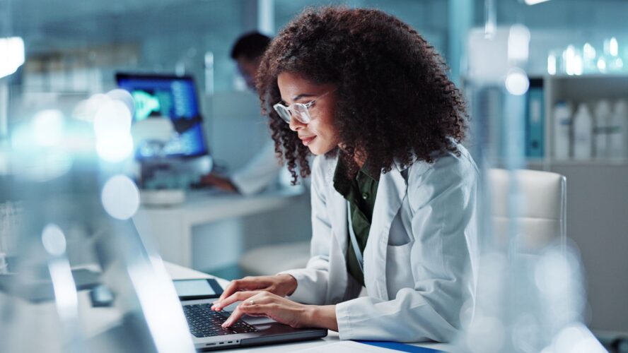 Woman. laptop and lab for research science or online internet for futuristic discovery, microscope or medicine. Female person, brainstorming and biotechnology for investigation, cure or development