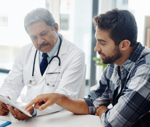 Cropped shot of a mature male doctor and patient having a discussion in the doctor's office before a checkup