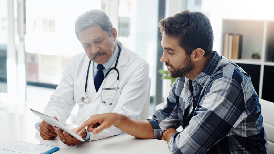 Cropped shot of a mature male doctor and patient having a discussion in the doctor's office before a checkup
