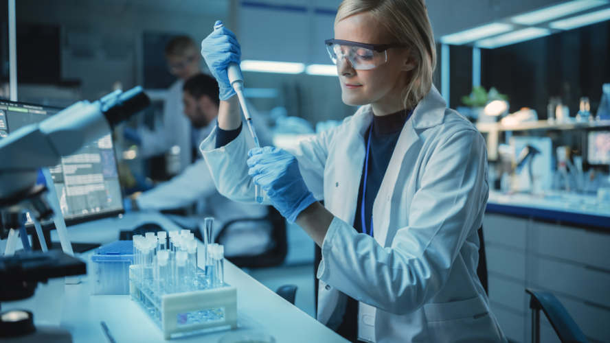 Female Research Scientist Uses Micropipette to Mix Liquids in a Sample Test Tube in a Modern Laboratory.