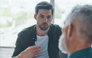 Handsome young man talking to his senior father