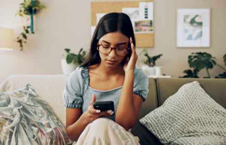 House, stress and woman with smartphone, headache and mistake with communication. Person, apartment and girl on couch, mobile user and cellphone with migraine, online reading and error message